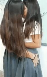 Lesbian schoolgirls kissing in the lounge